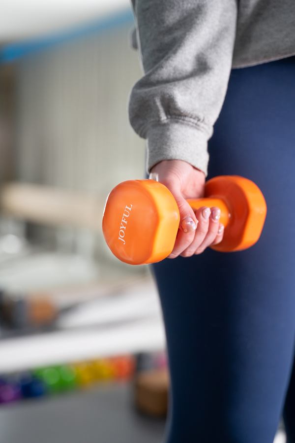 A branded Joyful orange hand weight