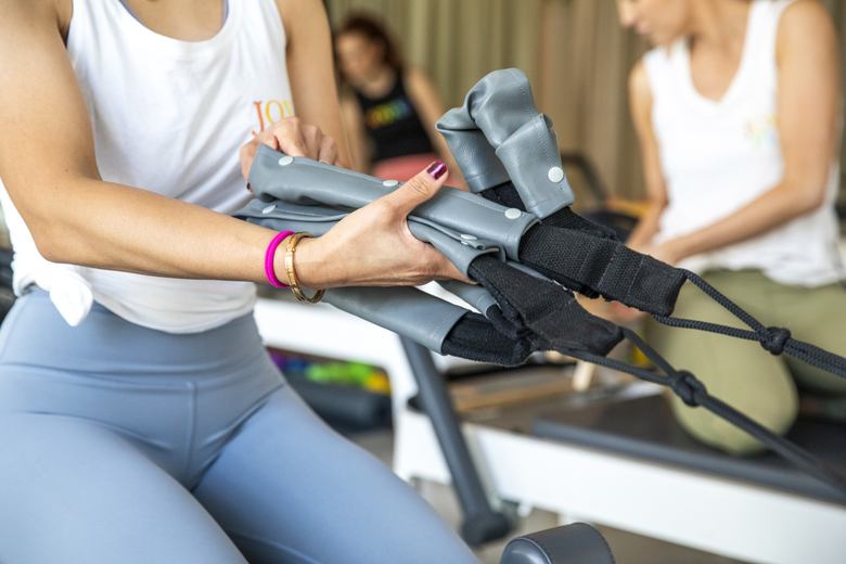 Close-up of the reformer straps during a Joyful Pilates class