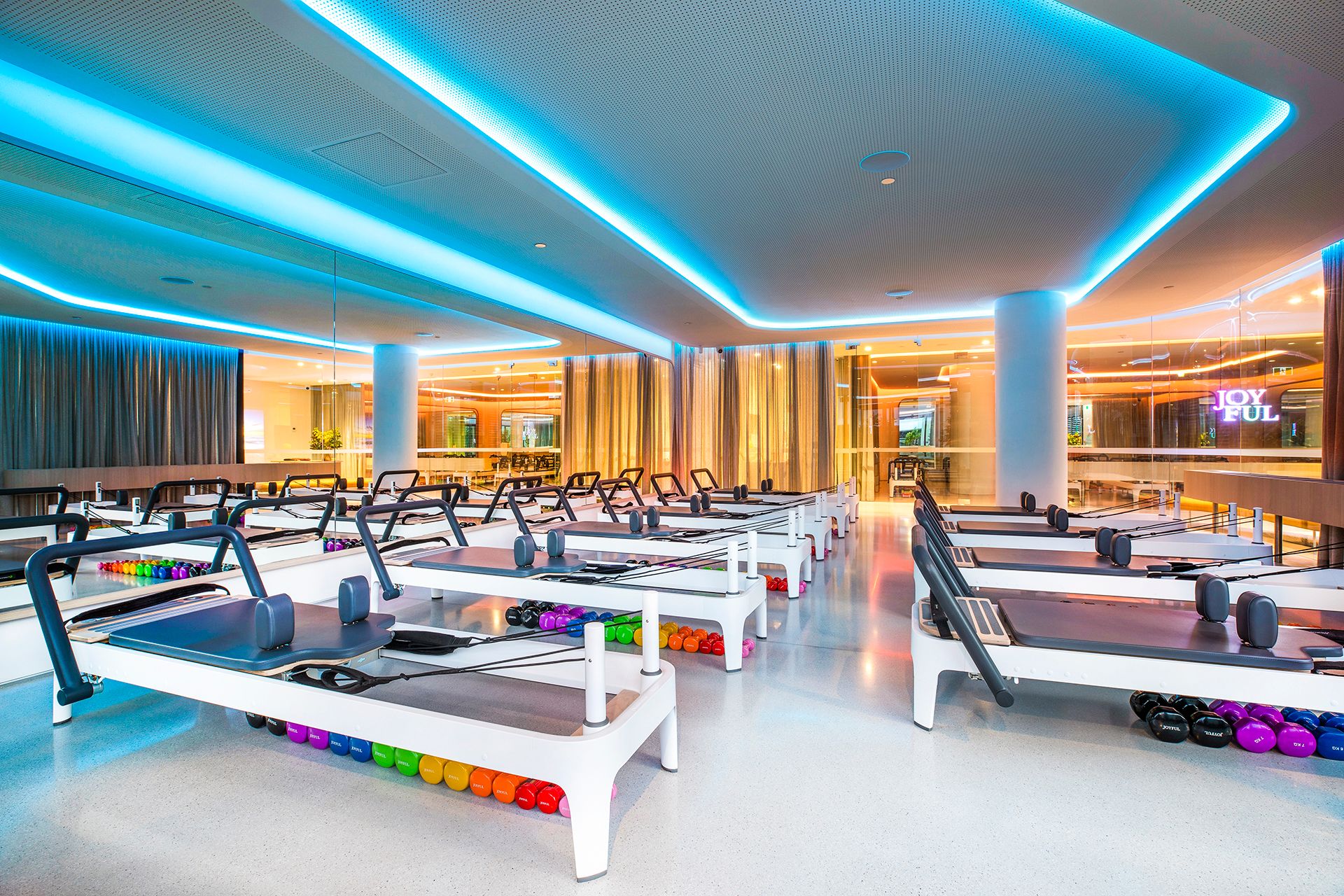 Joyful Pilates reformer studio, blue lighting