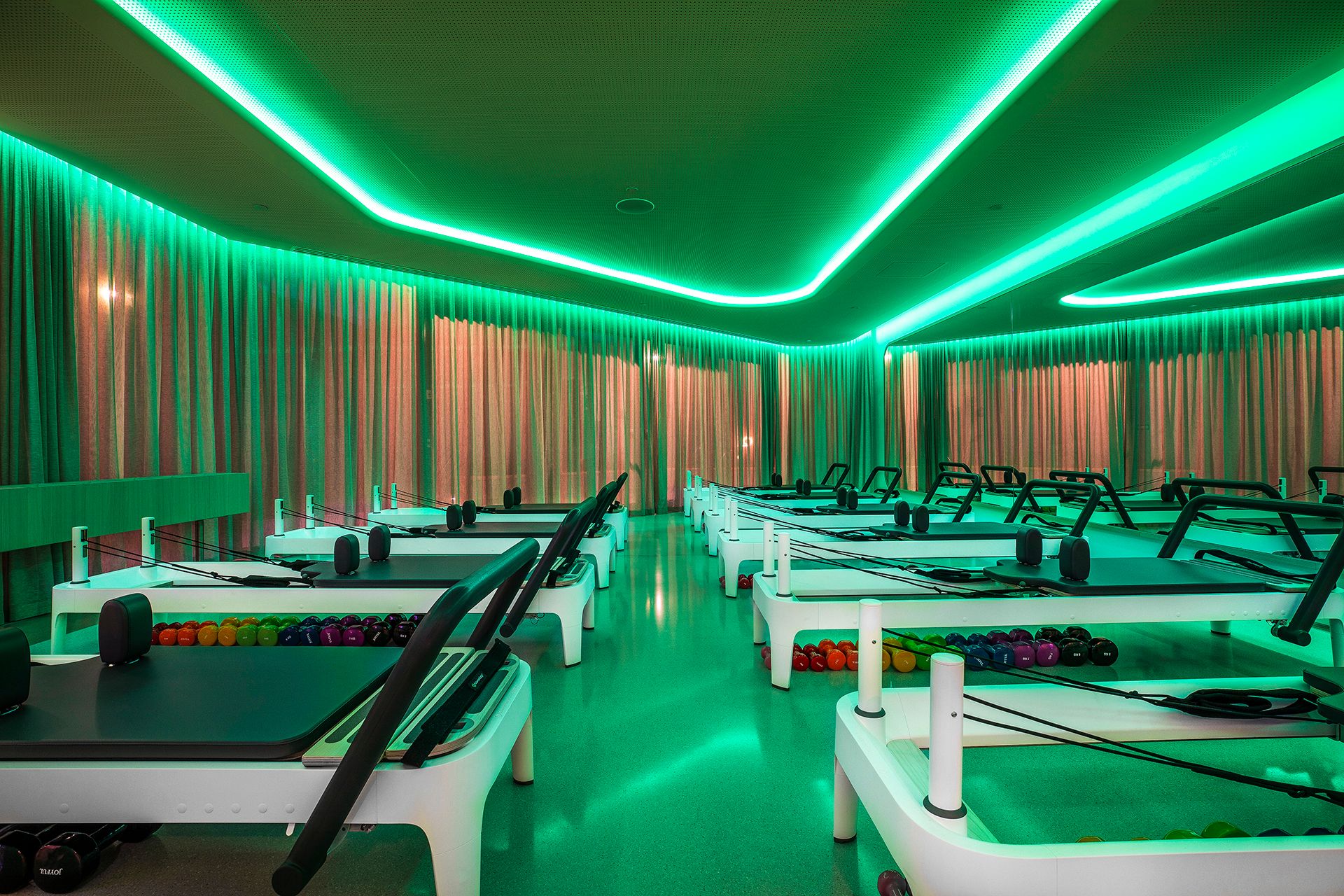 Joyful Pilates reformer studio, green lighting