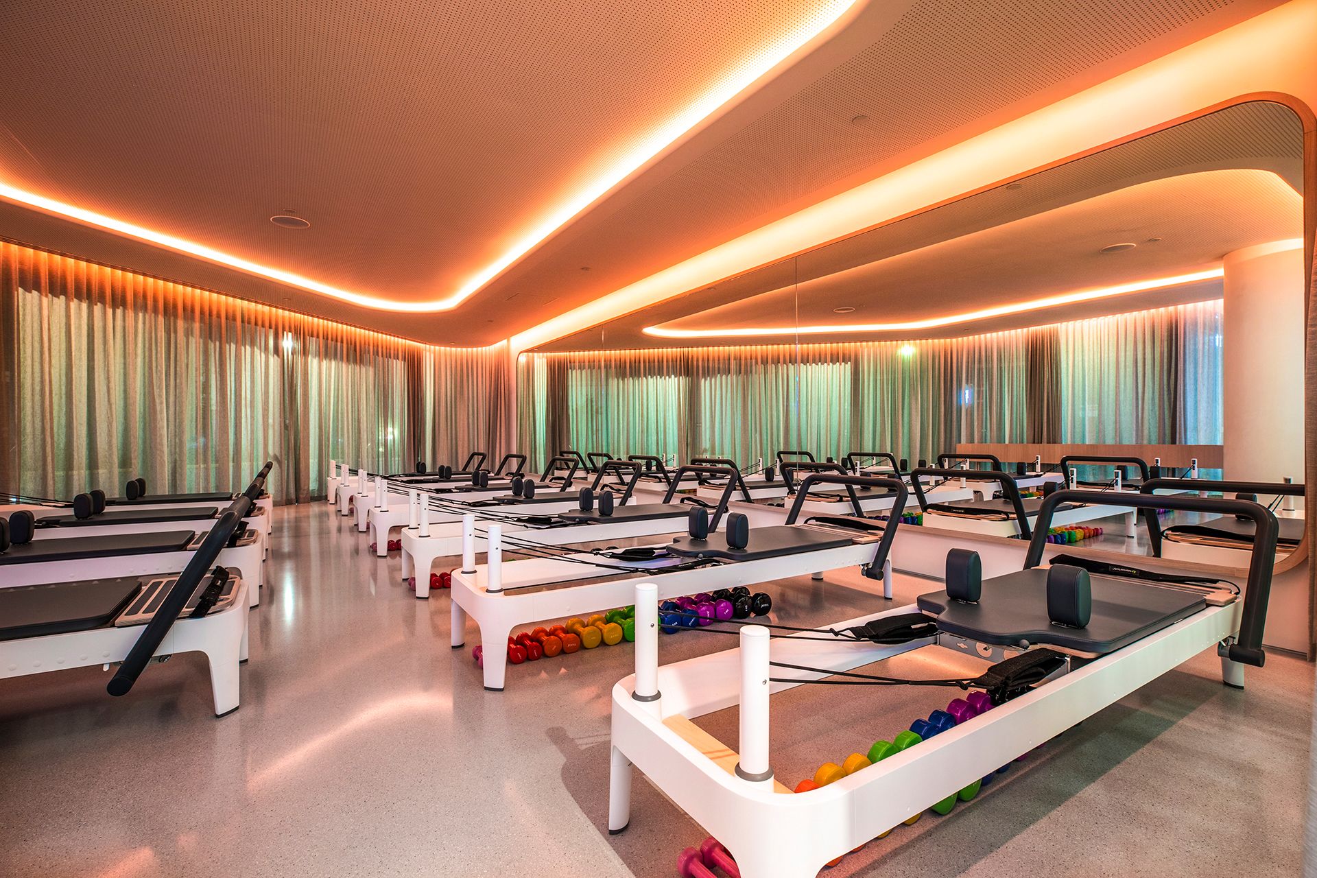 Joyful Pilates reformer studio, warm lighting